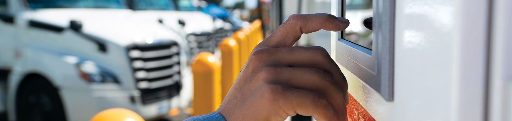 Finger touching a screen on an electric vehicle charging station