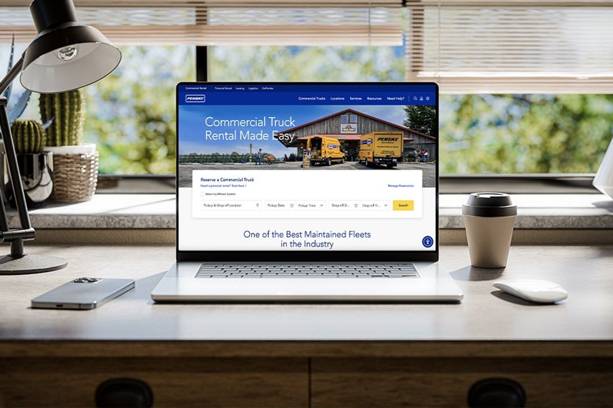 Newly revamped commercial truck rental site showcased on a laptop computer overlooking a green landscape.