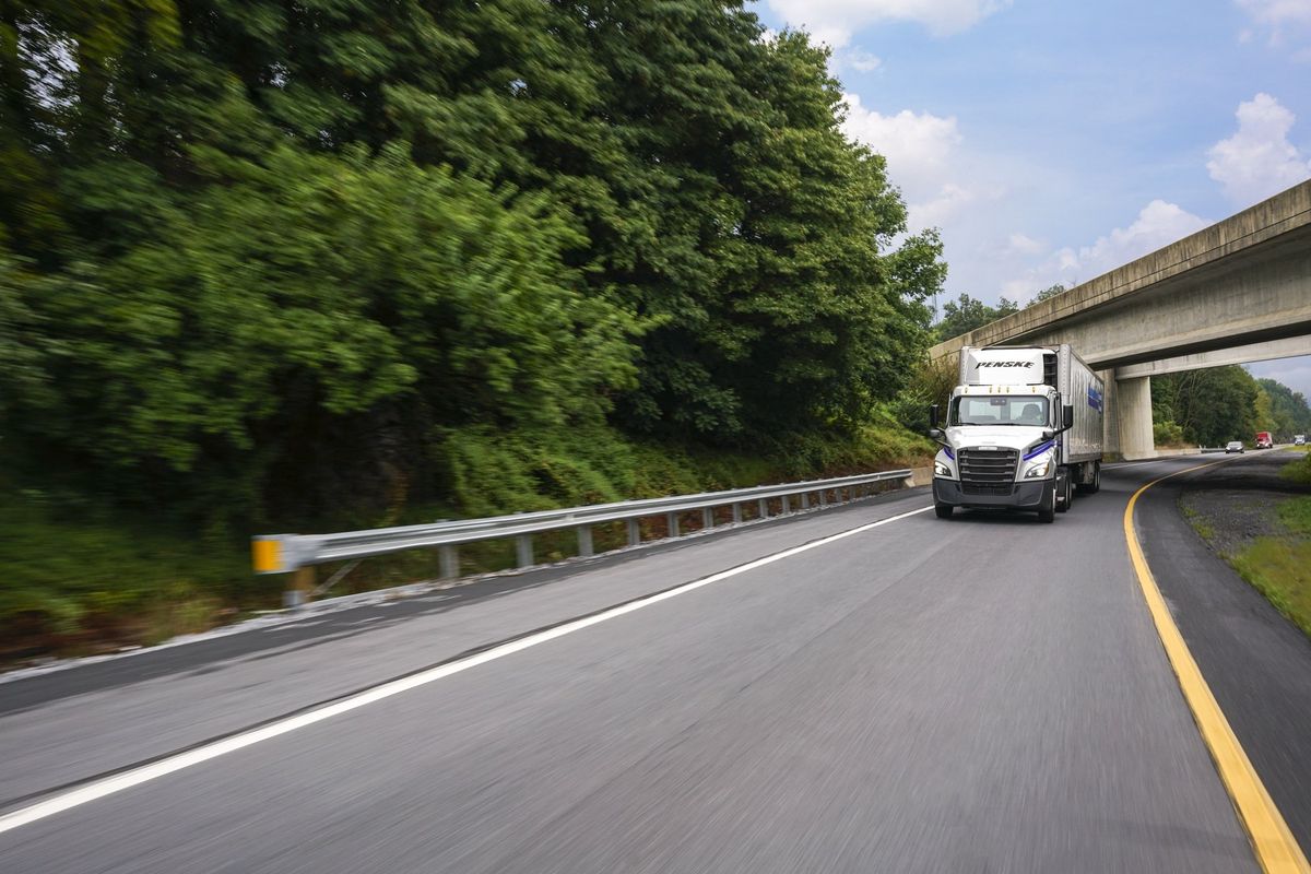 Penske truck driving on a highway
